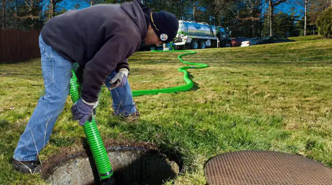 Service technician performing residential septic pumping and drainage maintenance in Indianapolis, IN